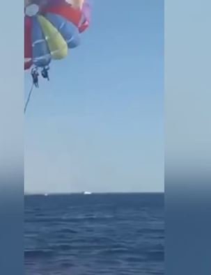 Camera captures moment shark leaps from ocean and attacks paraglider 4
