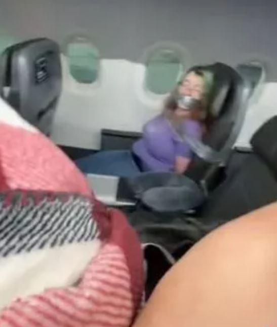 Woman duct-taped aboard American Airlines flight after trying to open the door mid flight 1