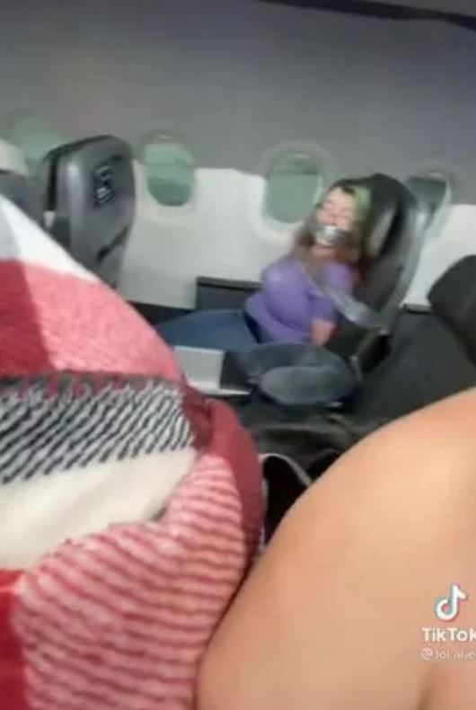 Woman duct-taped aboard American Airlines flight after trying to open the door mid flight 3