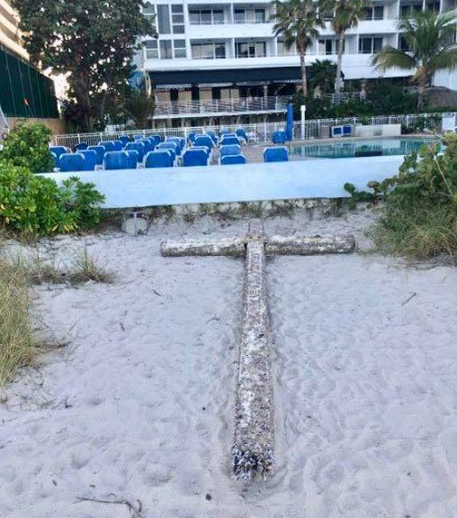 Beachgoer stunne after spotting a giant barnacle-covered cross washed up on a Florida beach 5