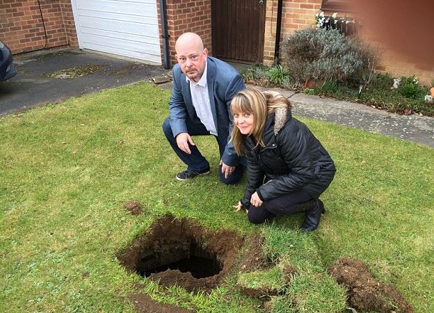 Family baffled after spotting rusty steps lead to mysterious 7ft-deep hole in their lawn 2