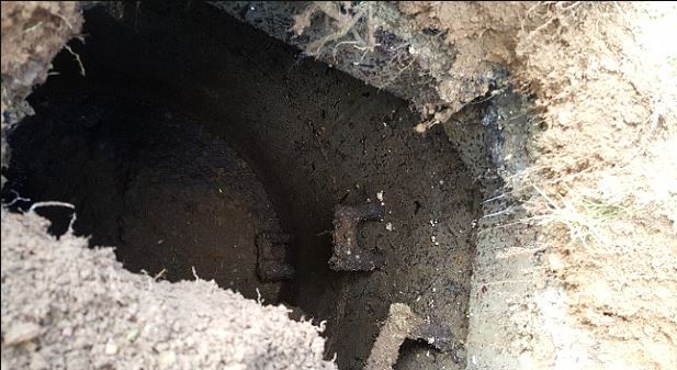 Family baffled after spotting rusty steps lead to mysterious 7ft-deep hole in their lawn 4