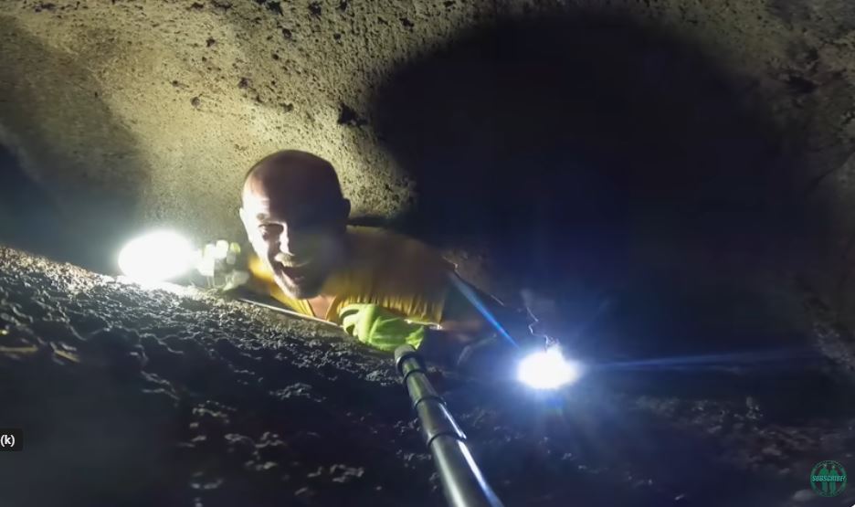 The video captured the intense moment when a man became trapped in a narrow cave, leaving shock and concern from viewers. Image Credits: @Caveman Hikes/YouTube.