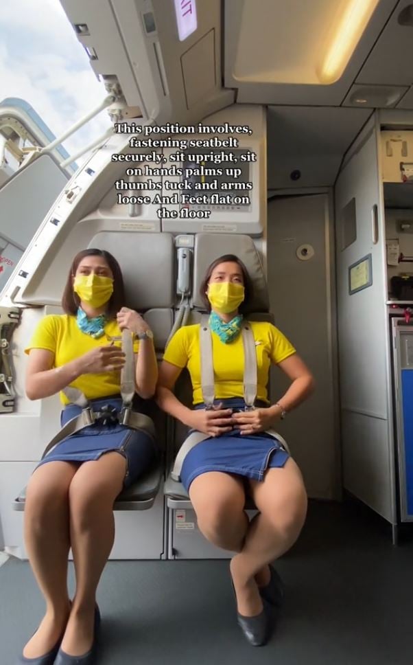 Why cabin crew sit on their hands during takeoff and landing: Flight attendant explained 1