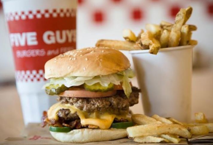 Five Guys hand-cuts potatoes for fries, ensuring quality across their menu offerings. Image Credits: Getty