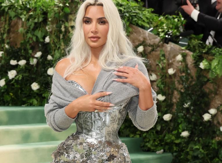 Kim Kardashian wore a silver corset dress paired with a cardigan at the Met Gala. Image Credits: Getty