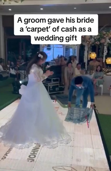Groom drapes crash sheet with $17,000 over bride's shoulder at wedding  6