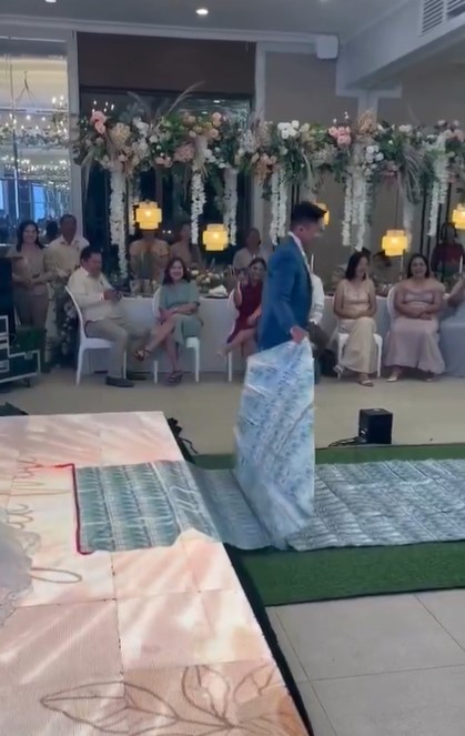 Groom drapes crash sheet with $17,000 over bride's shoulder at wedding  5