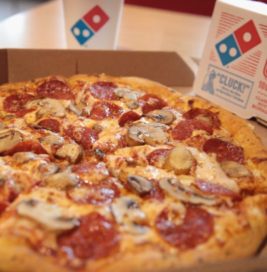 To redeem, customers must meet Domino's minimum order requirements. Image Credits: Getty