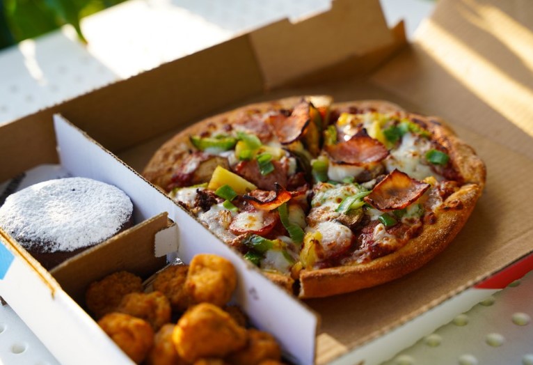 Domino's and Uber Eats collaborate to offer $10 million in free pizza. Image Credits: Getty