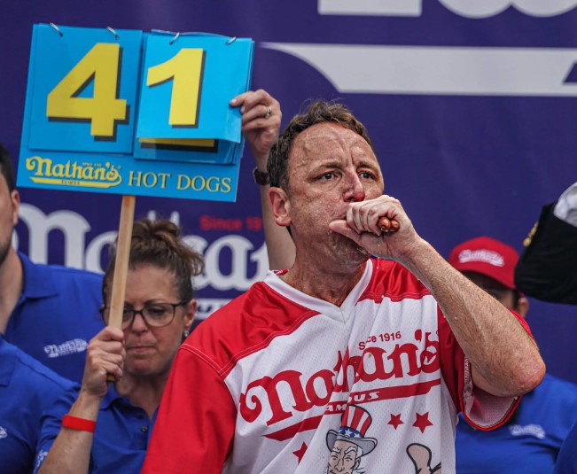 Contestants aim to eat the most hot dogs in ten minutes without vomiting.  Image Credits: Getty