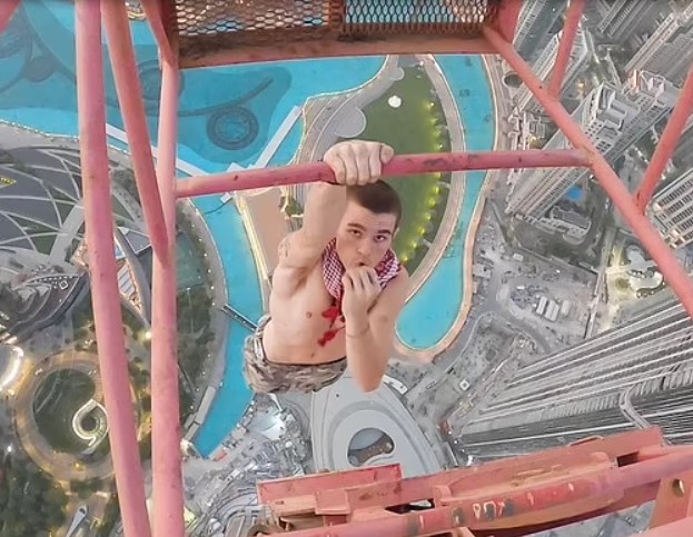 A daredevil scaled a 1,280ft crane in Dubai, finding it covered in grease. Image Credits: Adam Lockwood